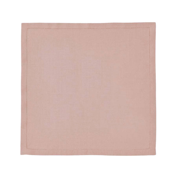 Blush pink linen napkin with hemstitch border by Alexandre Turpault on white background.