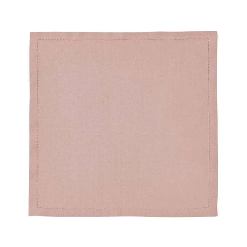 Blush pink linen napkin with hemstitch border by Alexandre Turpault on white background.