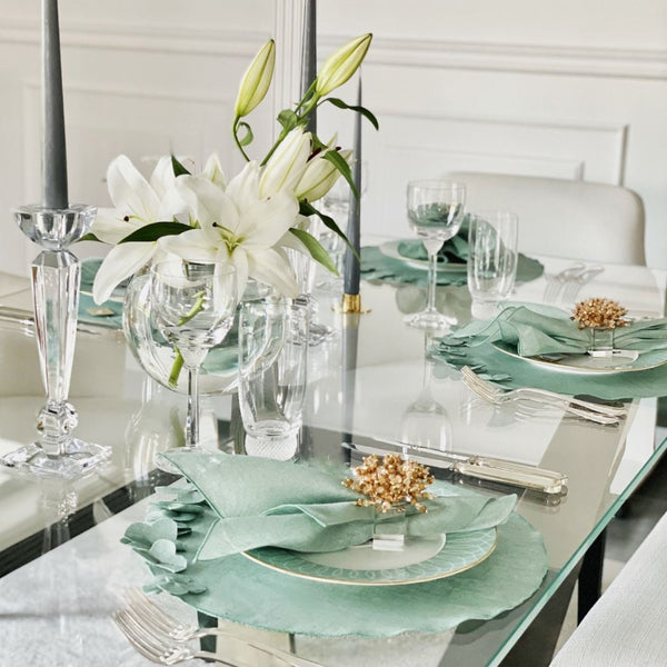Garza linen gauze napkin in sage green styled on elegant tablesetting with flowers, sold at Amiramour.