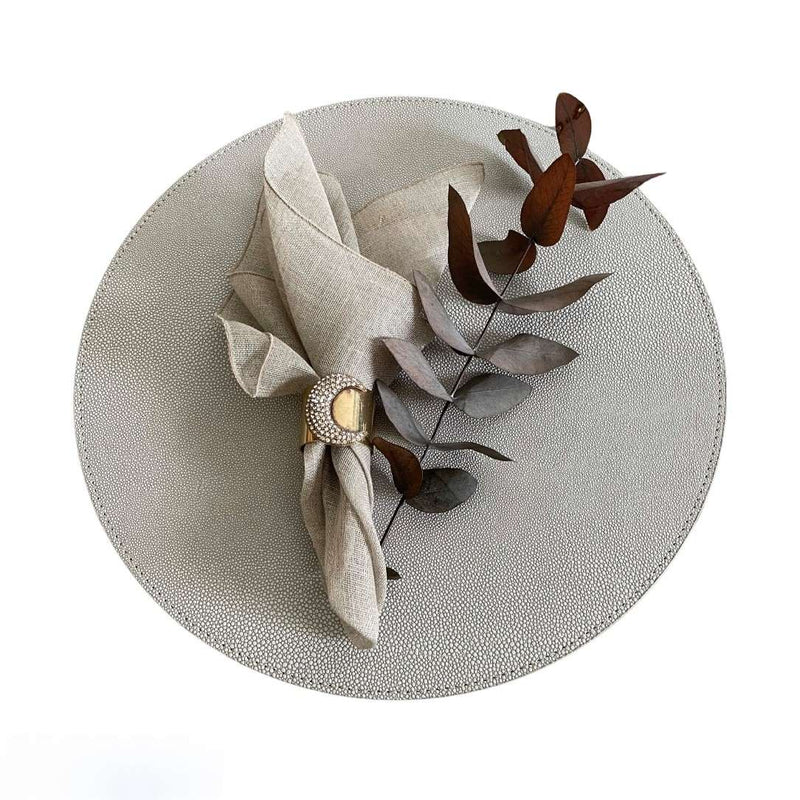 Soft, lightweight Garza linen napkin in styled on grey placemat with gold napkin ring - Amiramour
