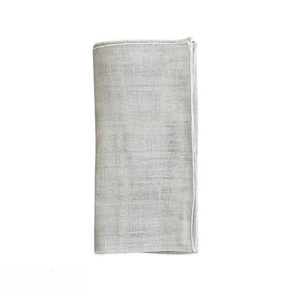 Garza grey linen napkin with piped edge, folded on white background, sold by Amiramour