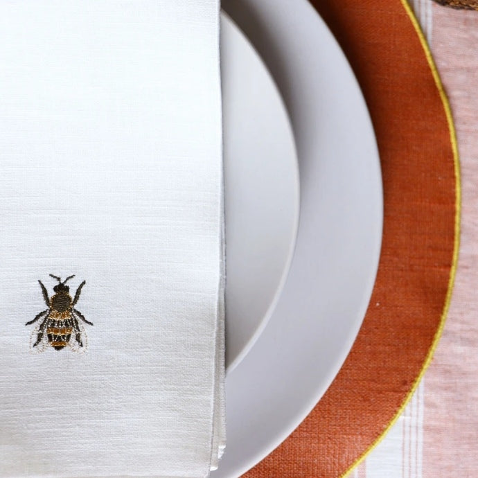Embroidered linen napkin with bee motif close-up