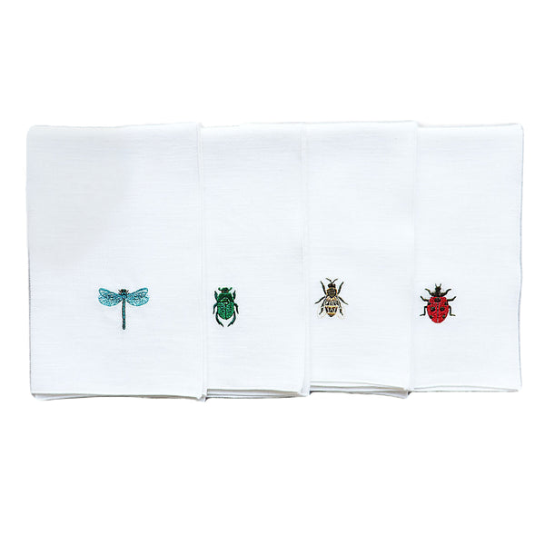 Folded Insetti linen napkins embroidered with insect motifs, white background sold on Amiramour