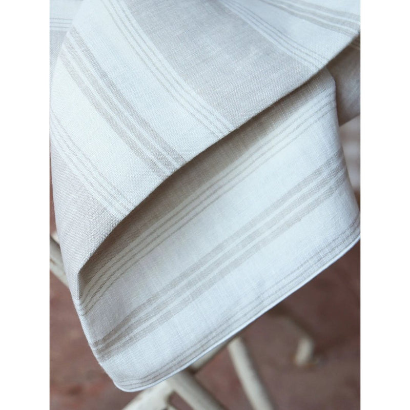 Close-up of Riva linen napkin showing stripe pattern and tonal piped edge