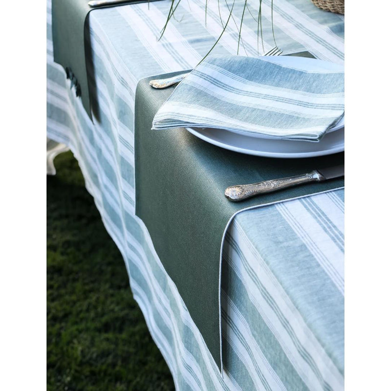 Riva green and white striped linen napkin with piped edge on Riva turquoise and white striped tablecloth.