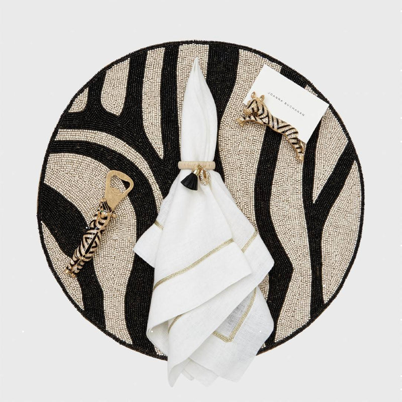 Gold Trim Linen Napkin In White by Joanna Buchanan styled on zebra print placemat