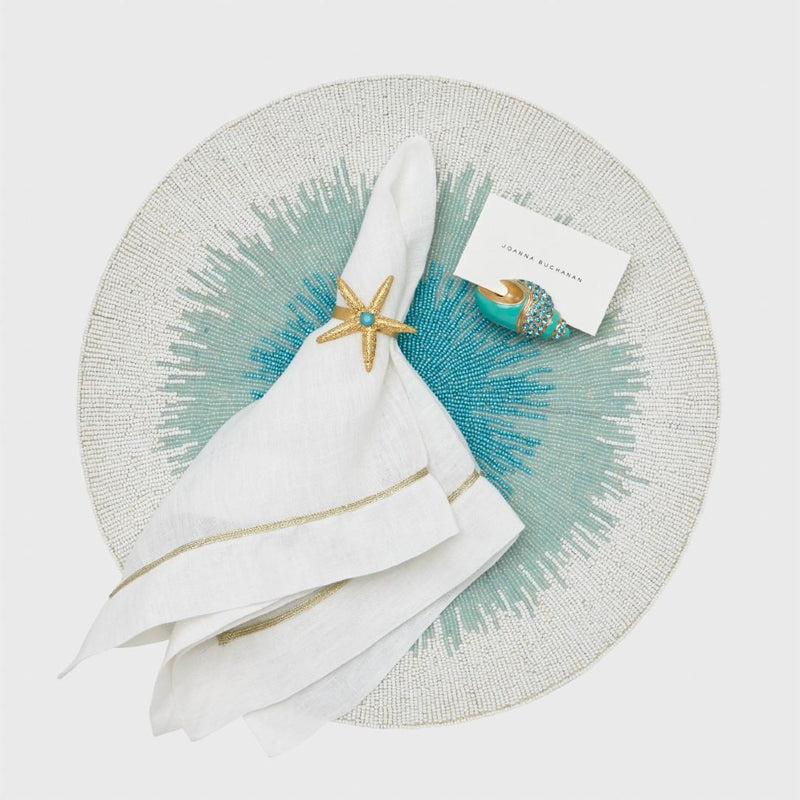 Gold Trim Linen Napkin In White by Joanna Buchanan styled with coastal table accessories