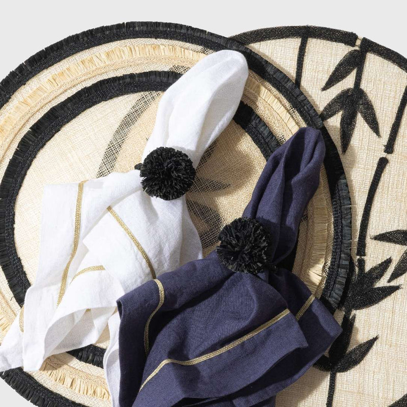 Gold Trim Linen Napkin In White by Joanna Buchanan styled with black pompom napkin ring