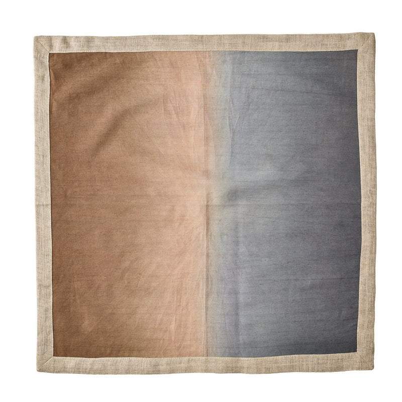 Beige, taupe, and grey linen napkin with metallic foil detail unwraped on white background.