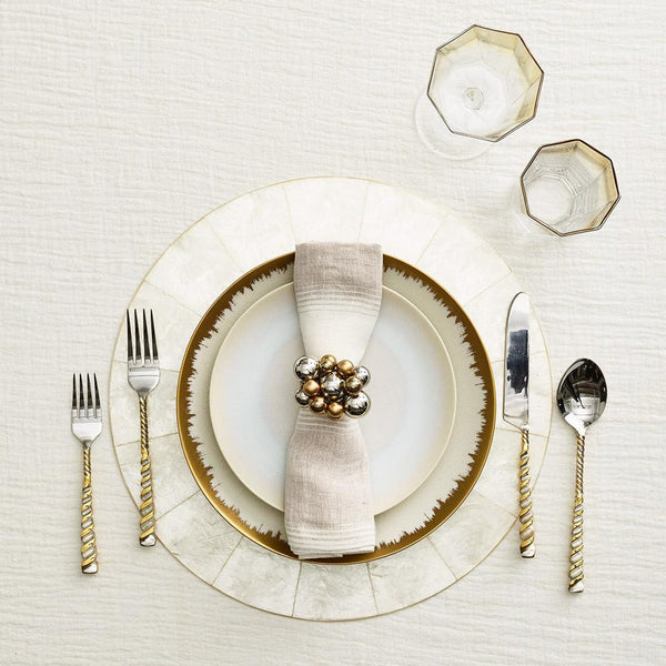 Baltic linen napkin styled on modern beige table setting with elegant napkin ring 