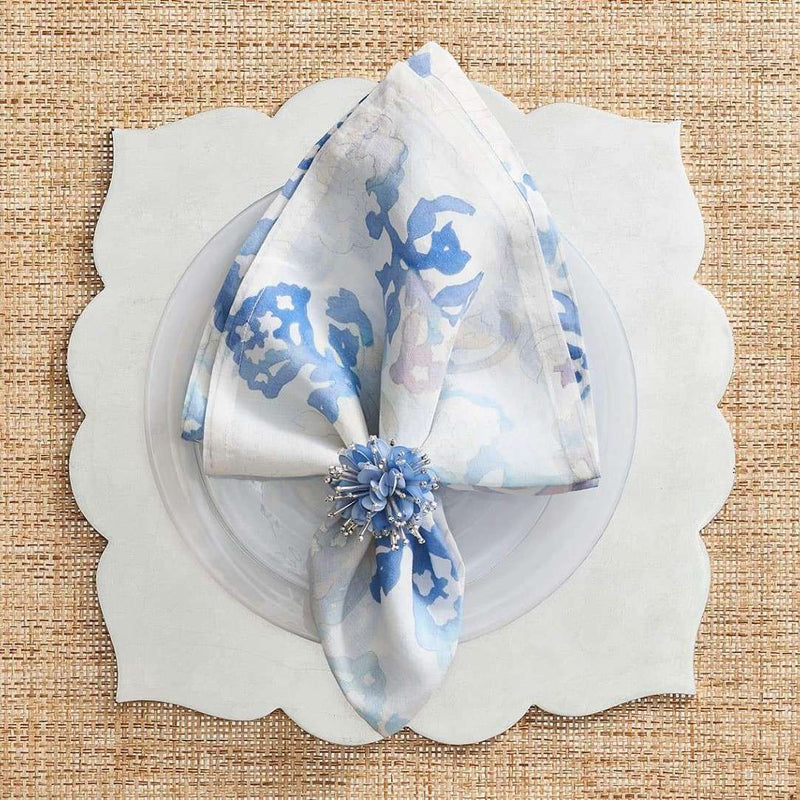 Styled watercolour napkin by Kim Seybert on white elegant placemat, sold at Amiramour.