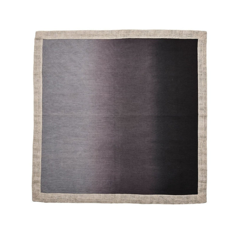 Unwrapped grey and black ombre linen napkin with metallic foil border on white background.