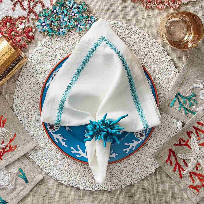 Jardin napkin on a marine-inspired table setting, top view, available at Amiramour