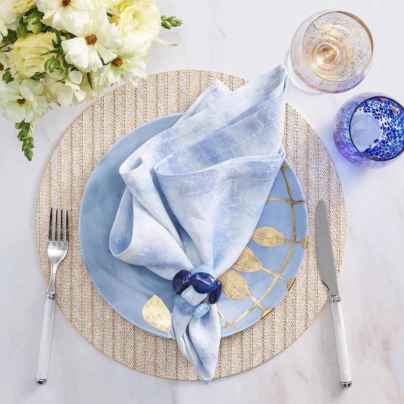 Luxury Sea Stone Napkin Ring in navy with natural stone design styled with gold placemat.