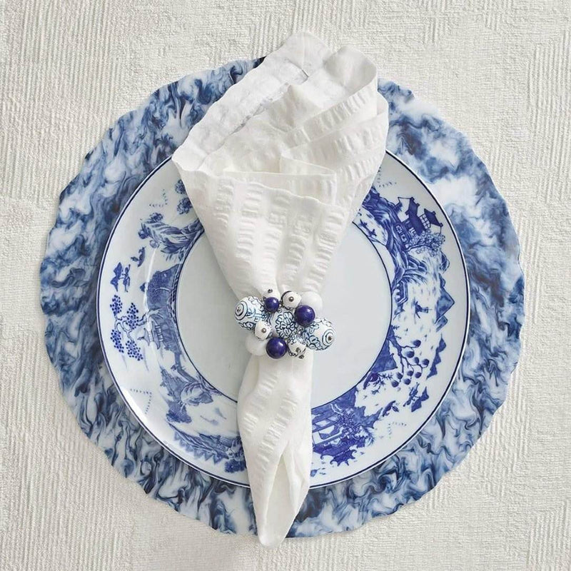 Asian table setting in white and blue with Cloud Napkin Rings by Kim Seybert