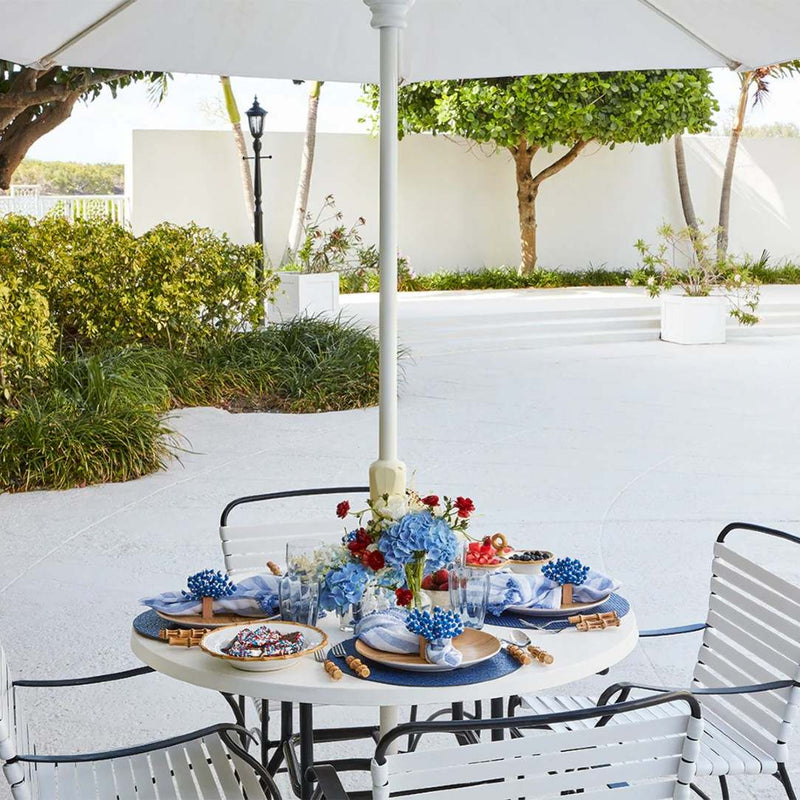 Full view of beach-inspired dining table with Reed Napkin Rings in blue and white