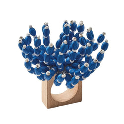 Front view of blue and white Reed Napkin Ring by Kim Seybert on white background