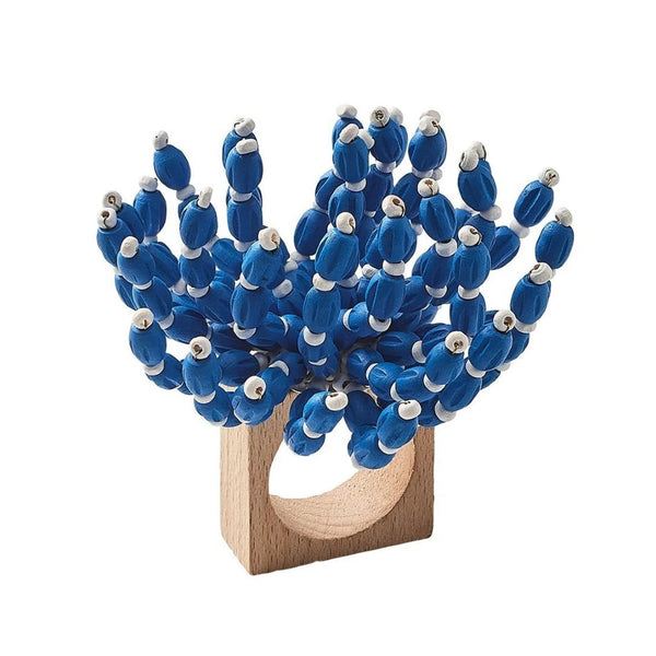 Front view of blue and white Reed Napkin Ring by Kim Seybert on white background
