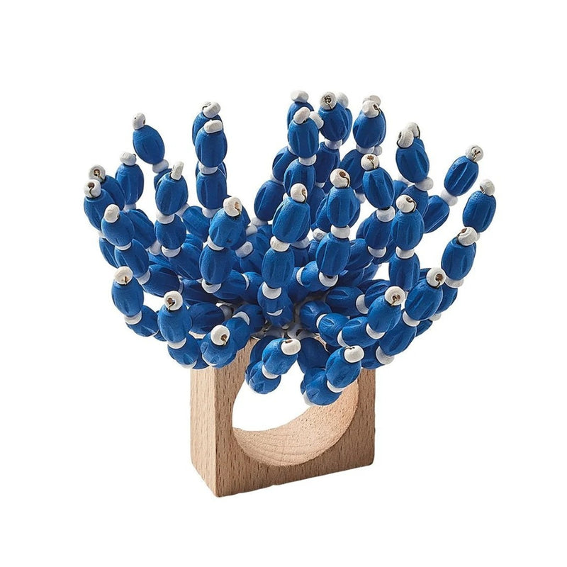 Front view of blue and white Reed Napkin Ring by Kim Seybert on white background