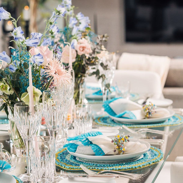 Spring table in white and turquoise tones featuring Spritz Napkin Rings by Kim Seybert, side view