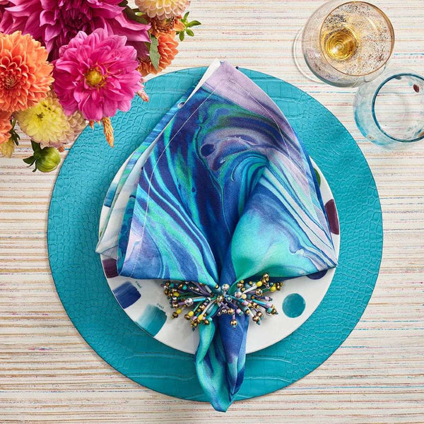 Vibrant turquoise and blue table setting featuring Fun Burst Napkin Rings by Kim Seybert