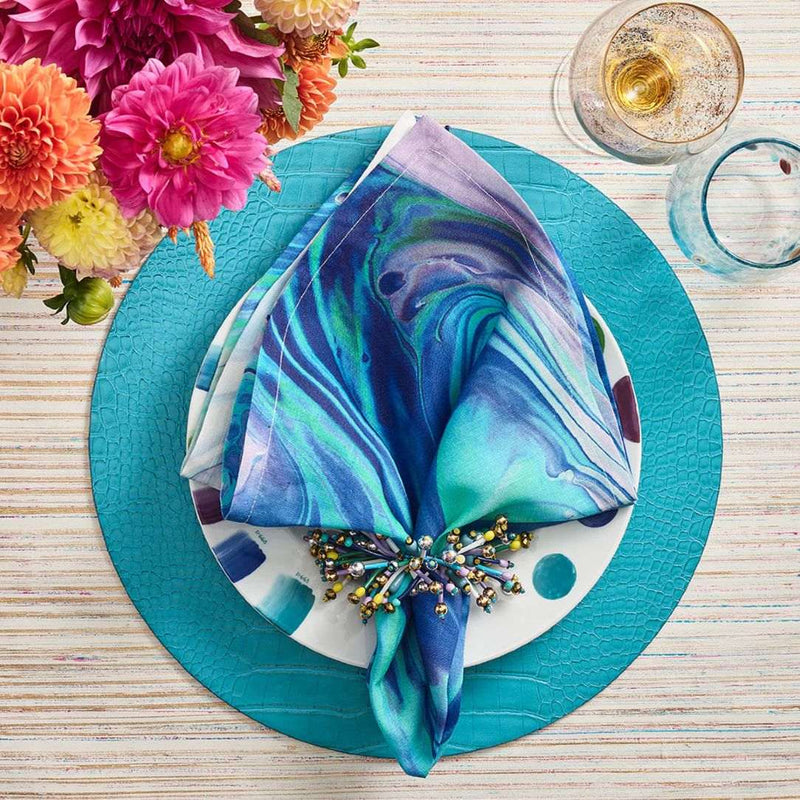 Vibrant turquoise and blue table setting featuring Fun Burst Napkin Rings by Kim Seybert