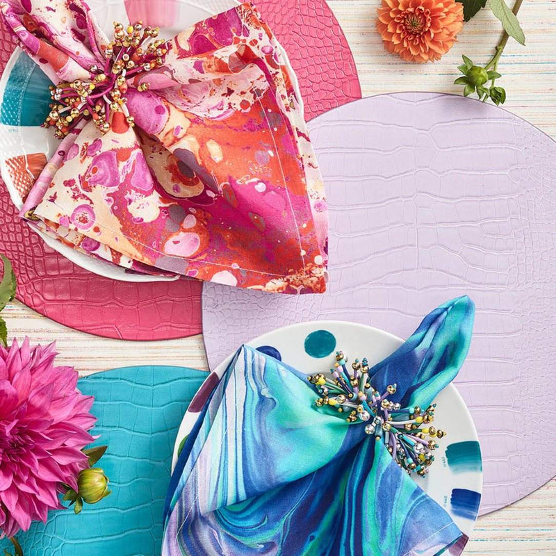 Fun Burst Napkin Rings in turquoise and pink on matching napkins in colorful spring table décor