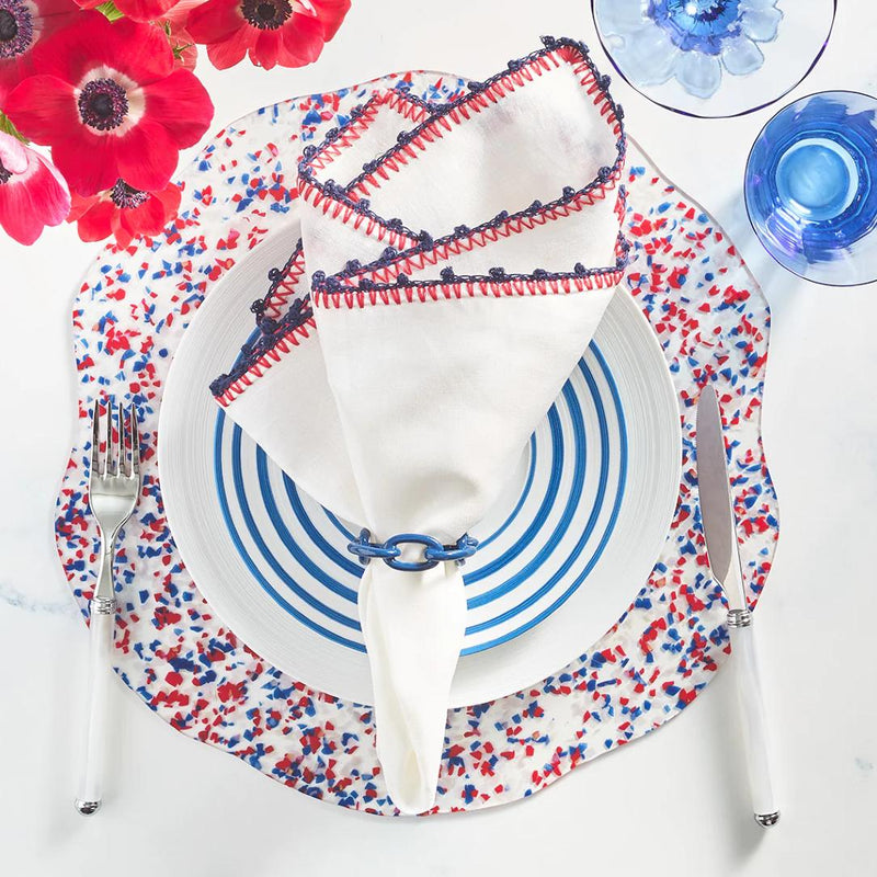 Summer table setting in white, blue, and red featuring Enamel Chain Link Napkin Rings by Kim Seybert