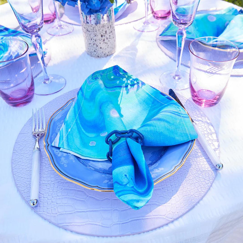 Vibrant blue and purple table décor highlighting navy enamel Chain Link Napkin Rings