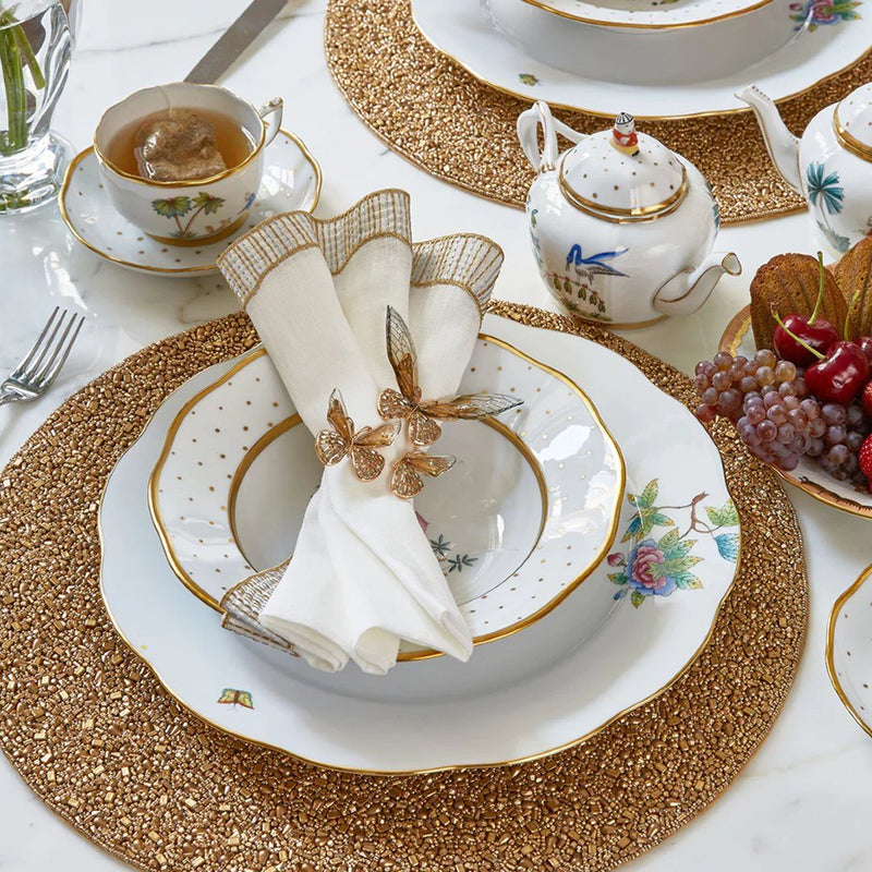 Gold and white table décor featuring delicate Flutter Napkin Ring by Kim Seybert