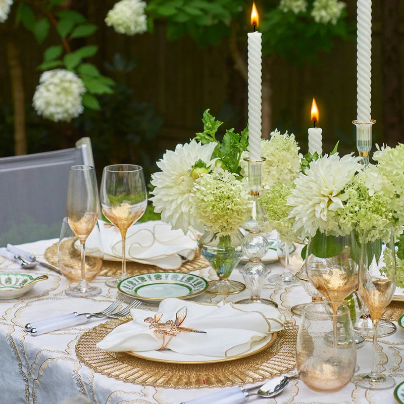 Spring table in gold, green, and white with Flutter Napkin Ring by Kim Seybert