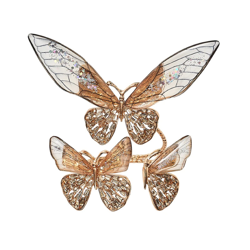 Top view of butterfly trio Flutter Napkin Ring by Kim Seybert in gold and champagne acrylic