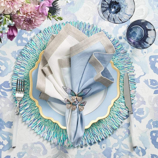 Elegant periwinkle-themed table setting with butterfly napkin rings by Kim Seybert