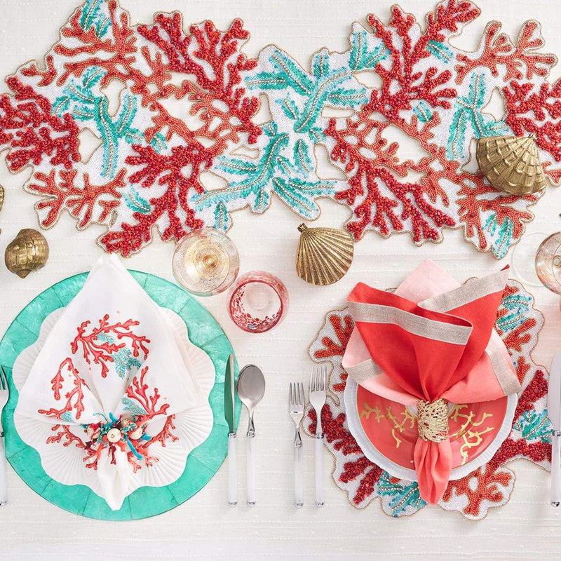 Coastal tablescape with Coral Cuff Gold Napkin Ring by Kim Seybert with coral and sea-inspired elements