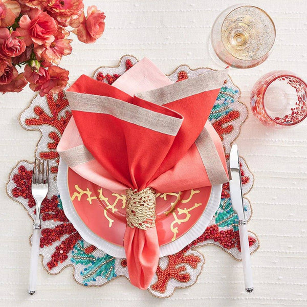 Mediterranean-inspired table setting with Coral Cuff Gold Napkin Ring and vibrant red coral accents
