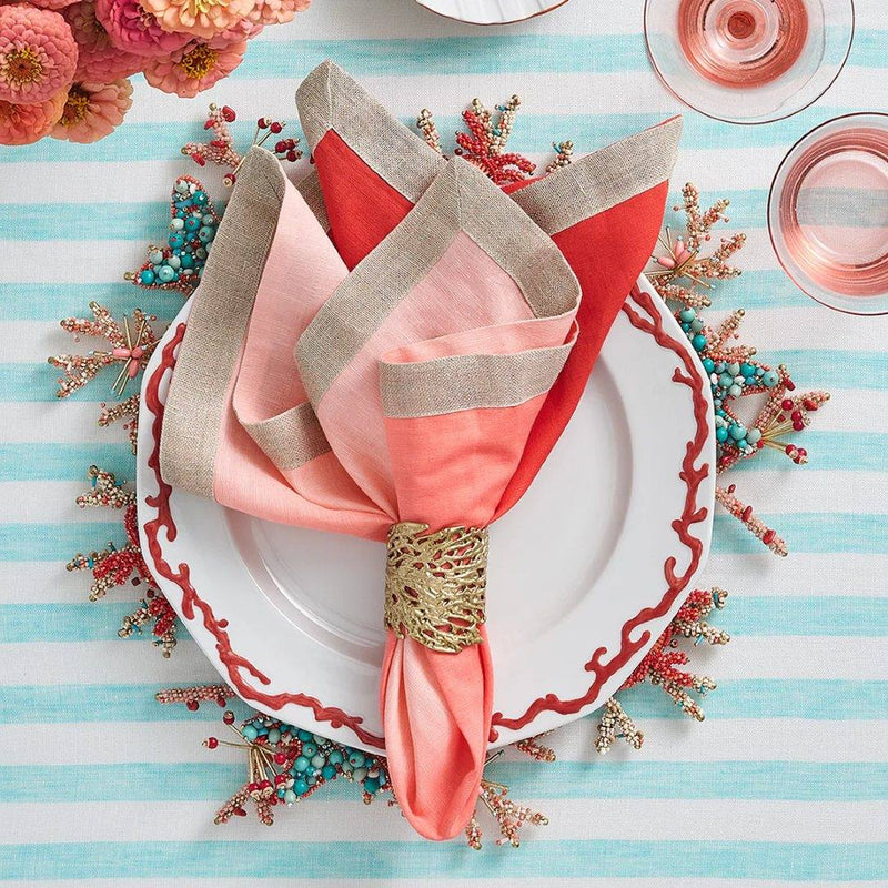 Elegant table scene with Coral Cuff Napkin Ring in Gold, featuring turquoise and coral red decor
