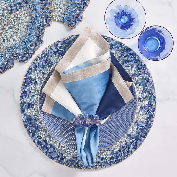 Table setting with navy blue Pop Rocks napkin ring and dark blue decor