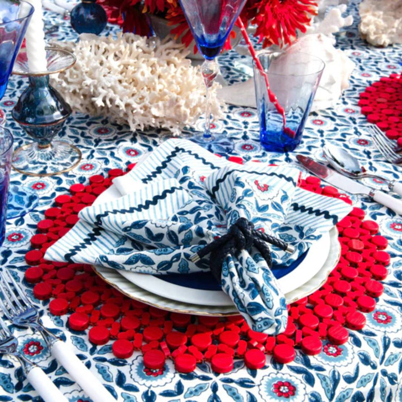 Luxury Rope Knot Napkin Ring in navy with handwoven nautical design on coastal red and navy tablescape.
