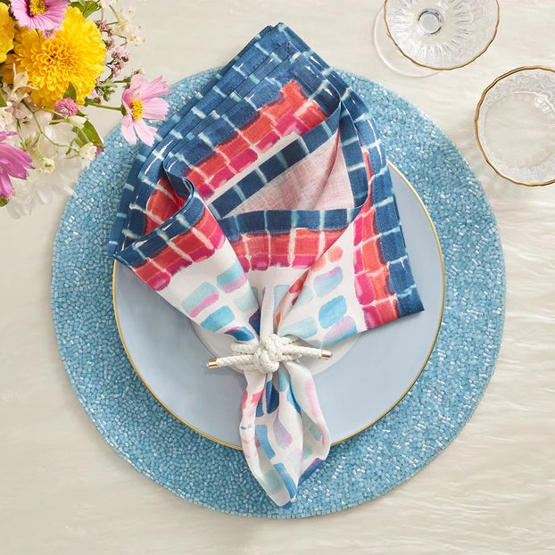 Luxury dining scene showcasing Kim Seybert’s white rope napkin rings