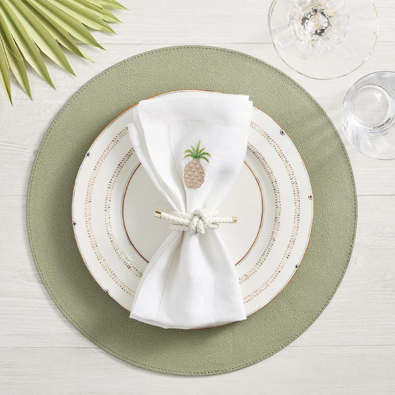 Rope Knot napkin ring in White by Kim Seybert on faux leather green placemat