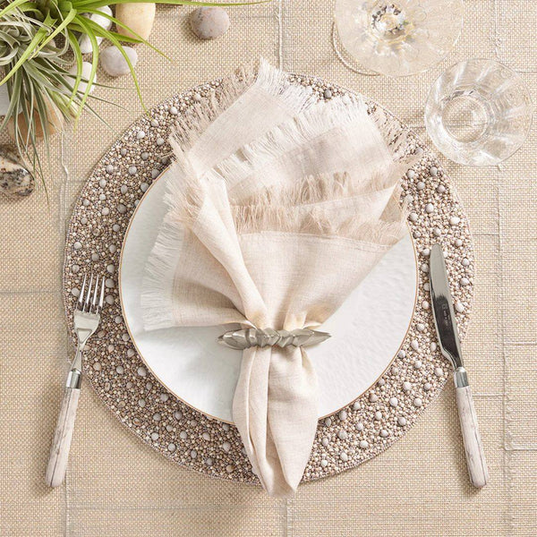 Cream and beige-toned tablescape accented with the Flame napkin ring in silver