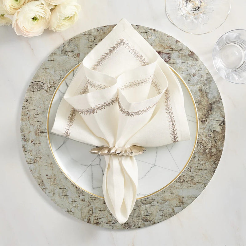 Elegant silver and white table setting featuring Kim Seybert’s Flame napkin ring