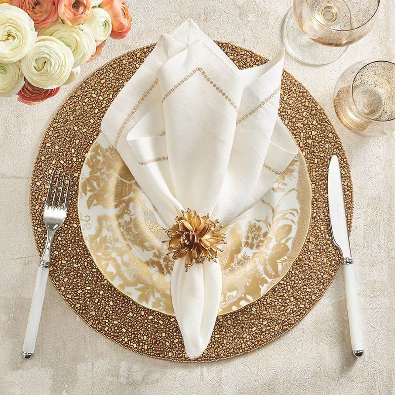 Elegant gold and white festive table setting featuring Starburst Napkin Ring by Kim Seybert