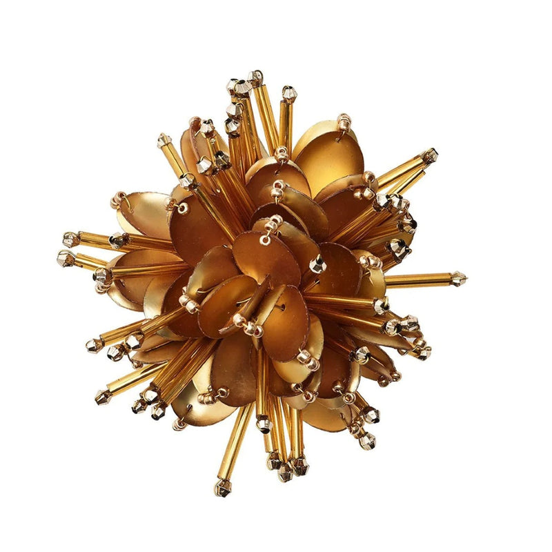 Top view of intricately crafted gold Starburst Napkin Ring by Kim Seybert