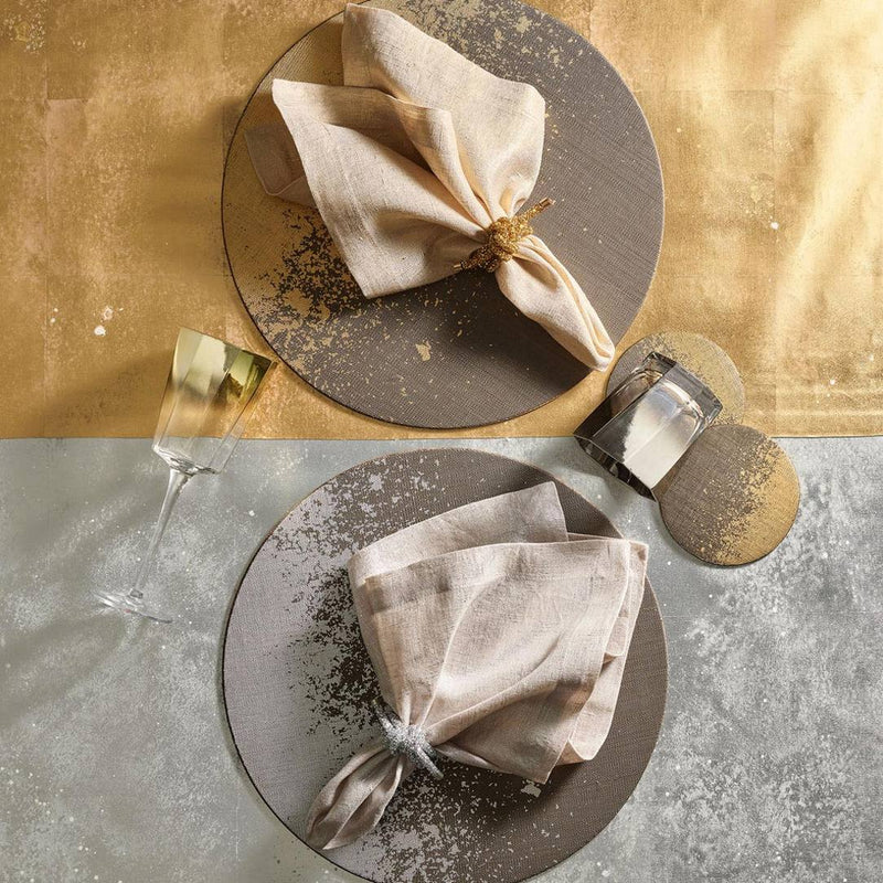 Side-by-side gold and silver Glam Knot Napkin Rings on matching napkins for comparison