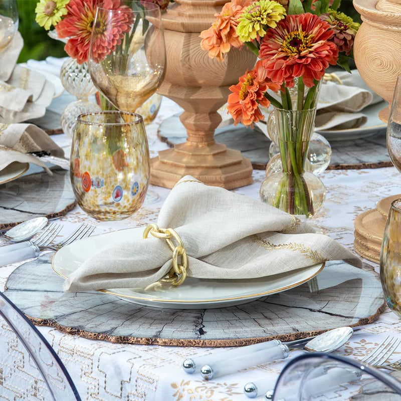 Pastel blue and nude dining setup with gold chain napkin ring by Kim Seybert, elegant detail from Amiramour
