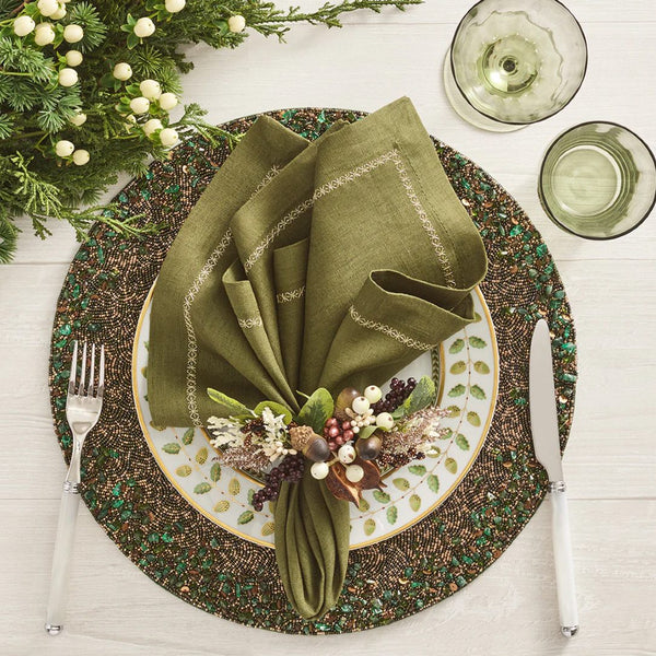 Multicolored Wildwood napkin ring styled on green beaded placemat.