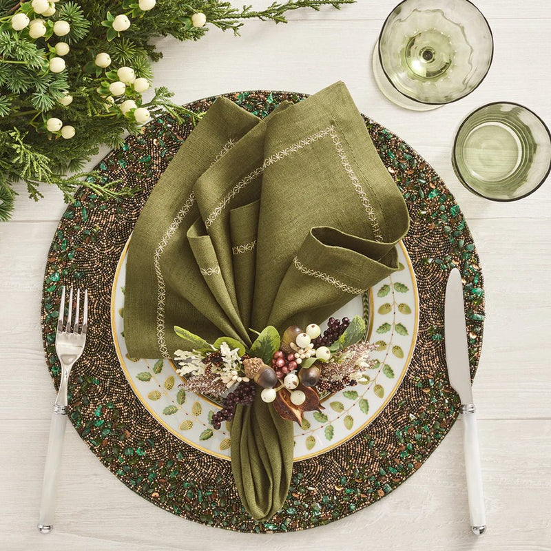 Multicolored Wildwood napkin ring styled on green beaded placemat.