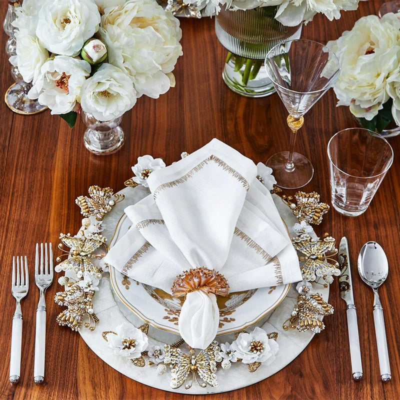 Close-up of floral table arrangement with white flowers and Dazzle Napkin Ring by Kim Seybert