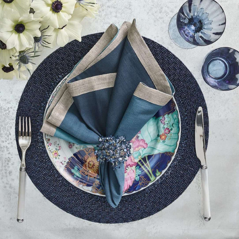 Elegant dark blue spring table setting with Aster Napkin Ring in midnight blue by Kim Seybert